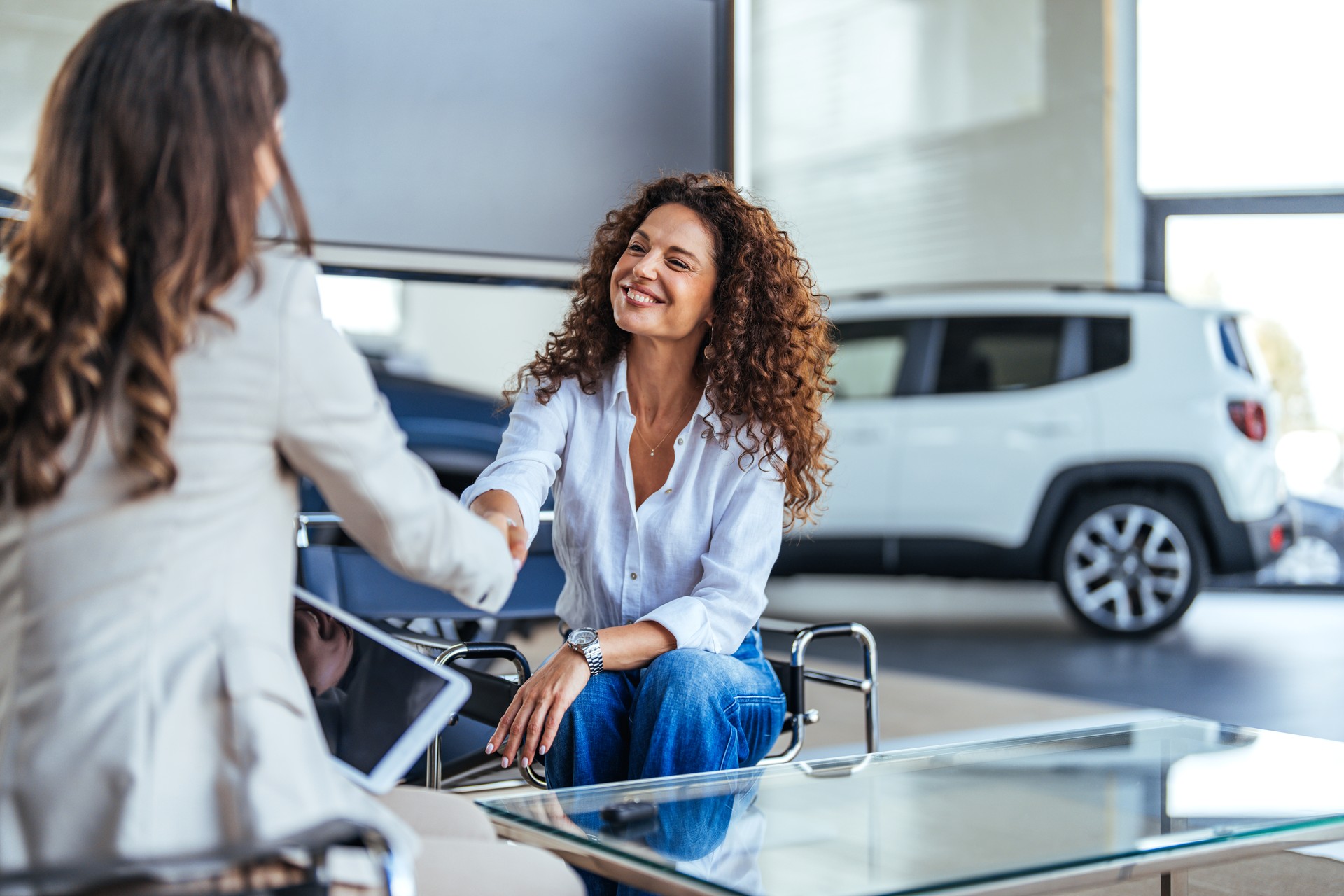 Saleswoman showing contract to customer.